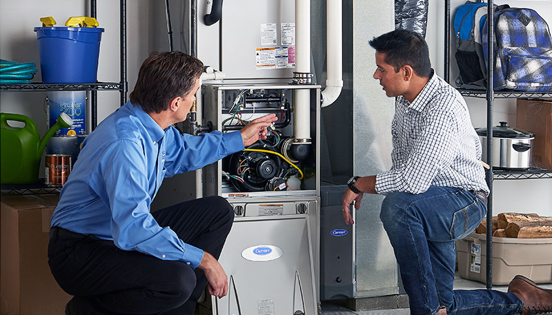 HVAC technician evaluating a furnace for repair or replacement in Brighton
