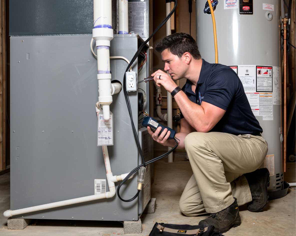 HVAC technician performing a furnace tune-up in Brighton